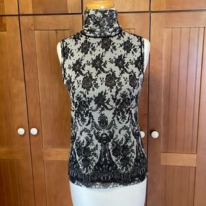Fuzzi sleeveless lace look stretch turtleneck top.